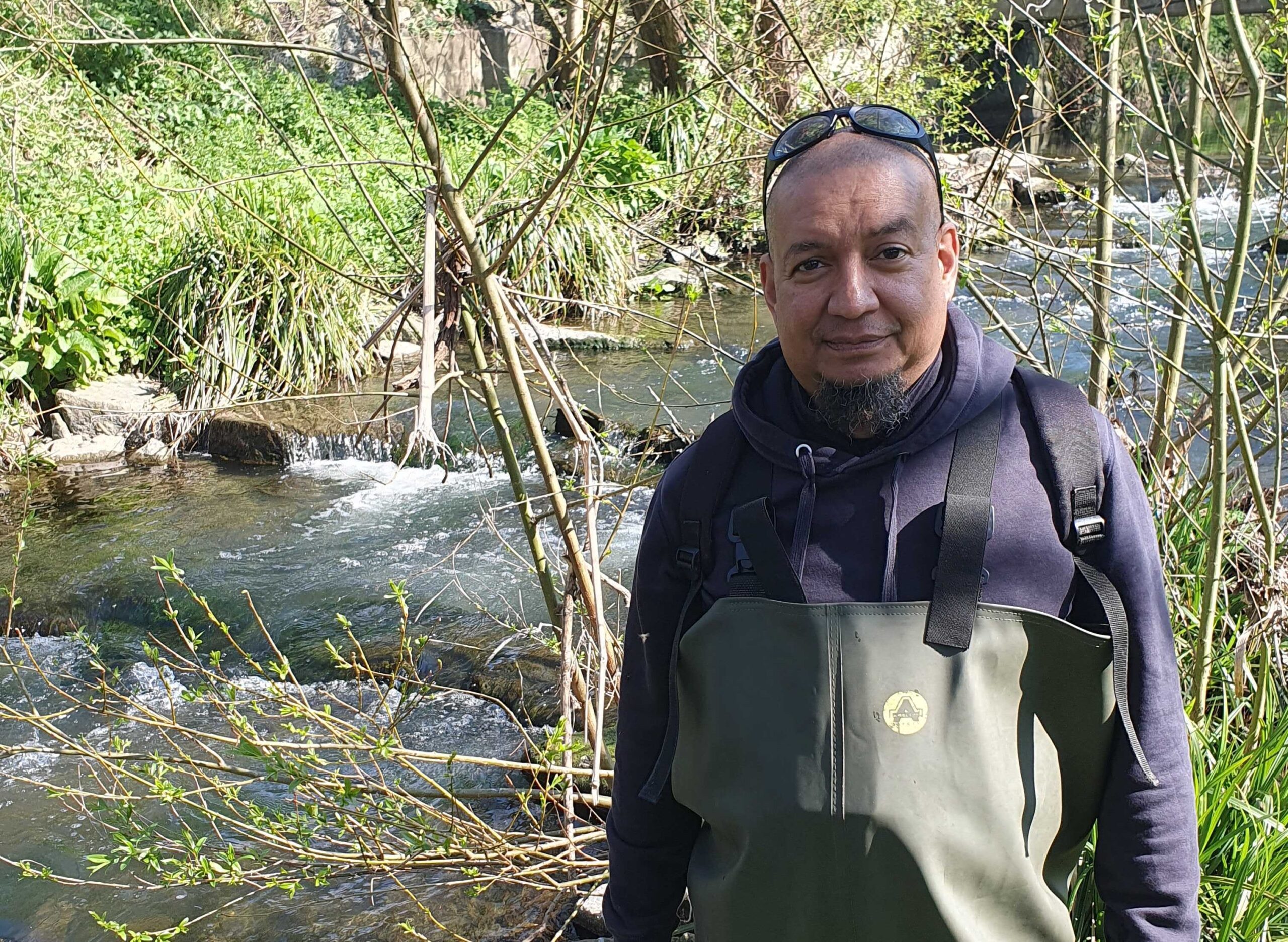 A man, Marc Fletcher, COO at South East Rivers Trust, standing on a riverbank.