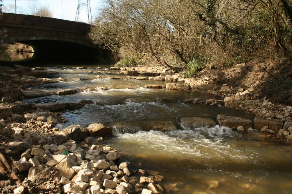 A rock ramp on the Hogsmill River restoring fish passage at the A240 bridge