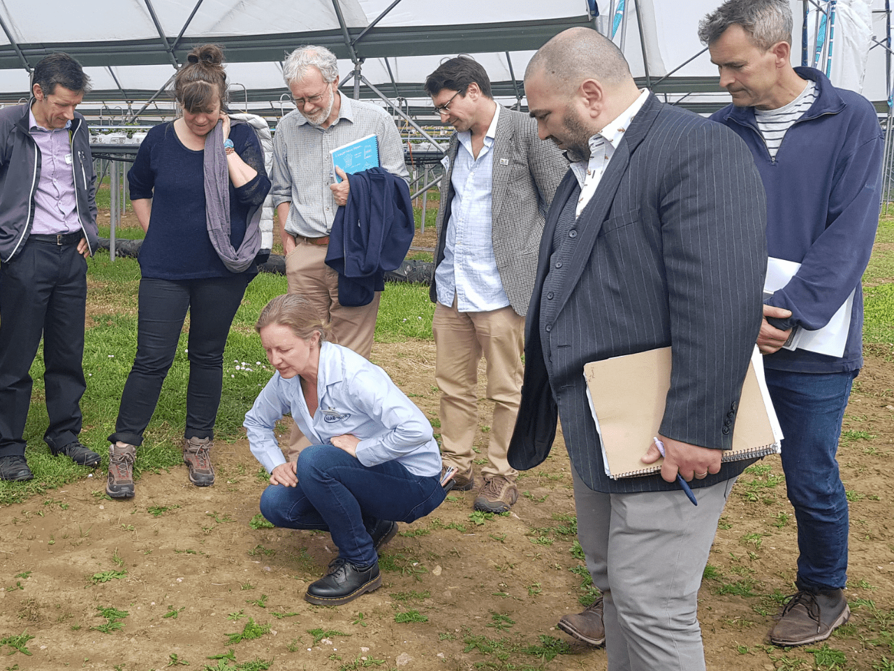 A group of people, meeting together in a polytunnel